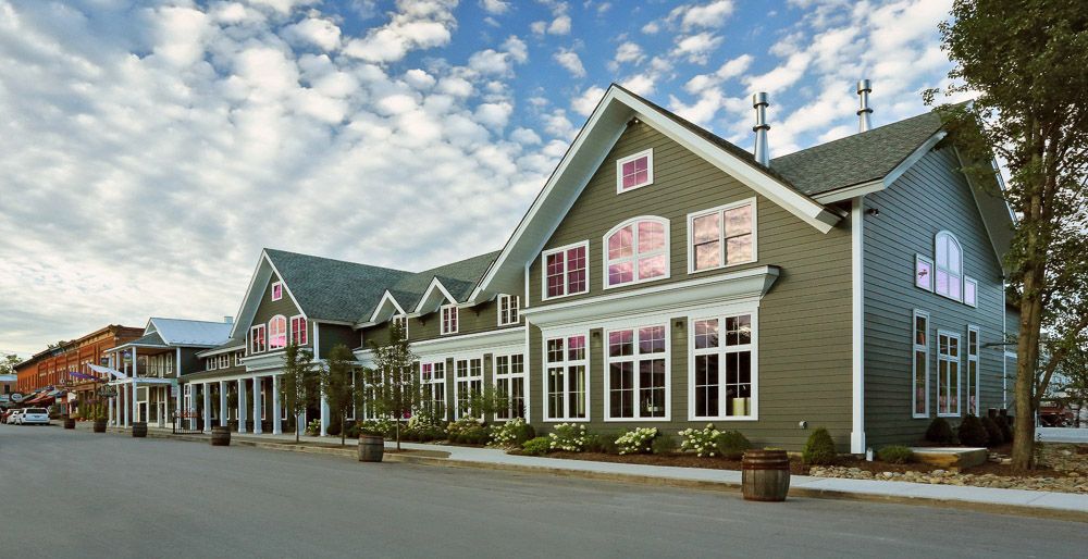 Large two-story commercial brewery with exposed timbers on a small town street in Ellicottville NY.