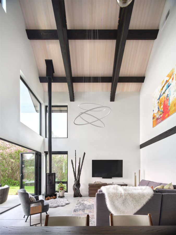 Patio entrance through sliding glass doors from white, modern living room.