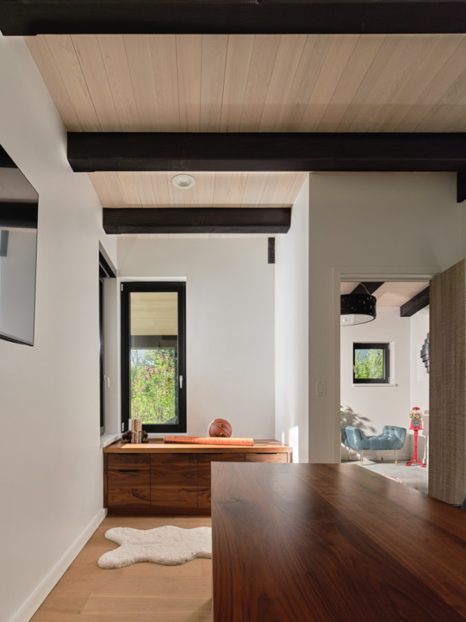 Office space with hardwood floors, maple desk, fur throw-rug