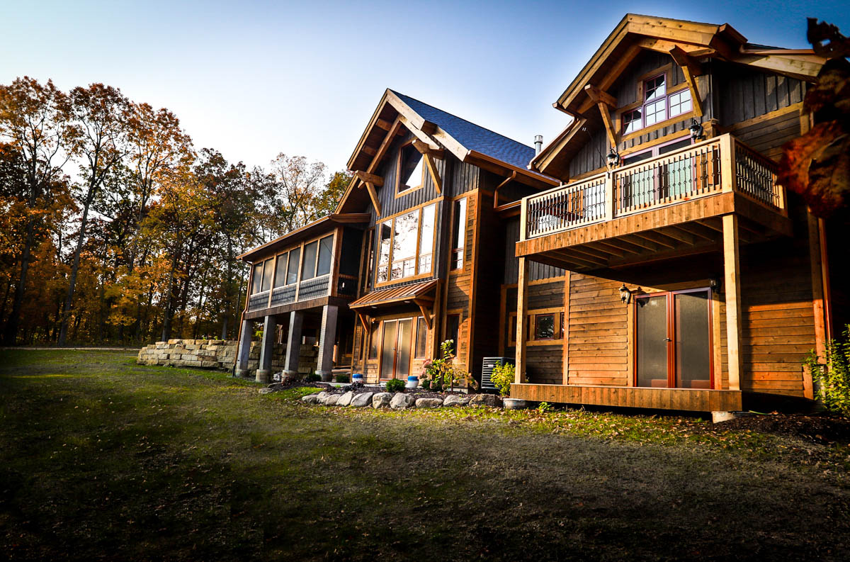 Backside of home with multiple porches and decks